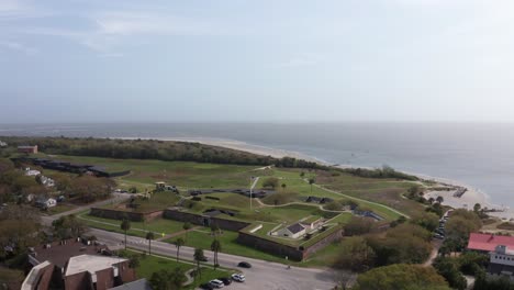 Rising-and-panning-aerial-shot-of-historic-Fort-Moultrie-during-a-hazy-day-on-Sullivan's-Island,-South-Carolina