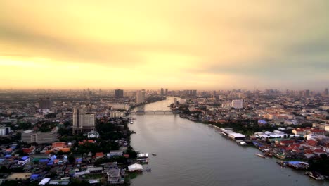 buildings and chao phraya river at sunset in bangkok city, thailand. 4k cityscape vdo