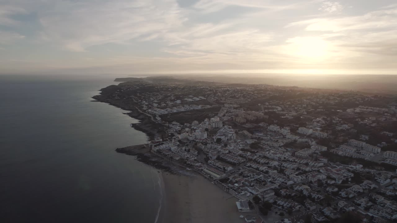 Dusk Glimmering wide horizon of Algarve Praia da Luz coastline. Aerial
