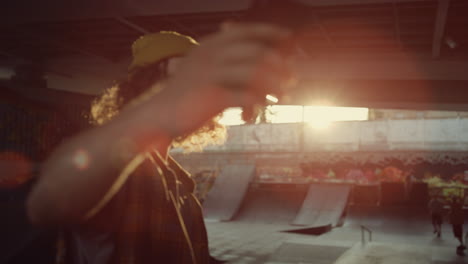 teenager posing mobile phone camera at skate park. man taking selfie photo.