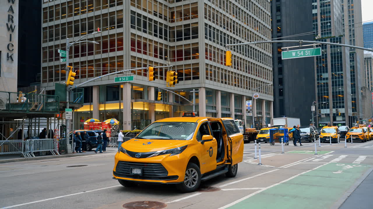 New York, USA, 15 March 2026: Yellow taxi cab on New York City street near skyscrapers. Yellow Toyota Sienna wheelchair accessible taxi stopped at a street corner in Manhattan, New York