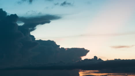 sun rays and glowing red cloud formations as a cumulonimbus cloud form during south east asia monsoon season