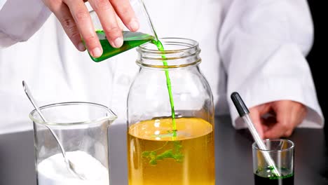 a scientist pours green liquid into a jar, creating a vibrant chemical reaction in a laboratory setting