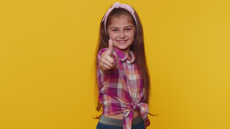 happy preteen child girl kid looking approvingly at camera showing thumbs up, like positive sign