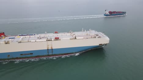 4k 30fps aerial drone flight following two container ships in the isle of wight heading out to sea in the english channel