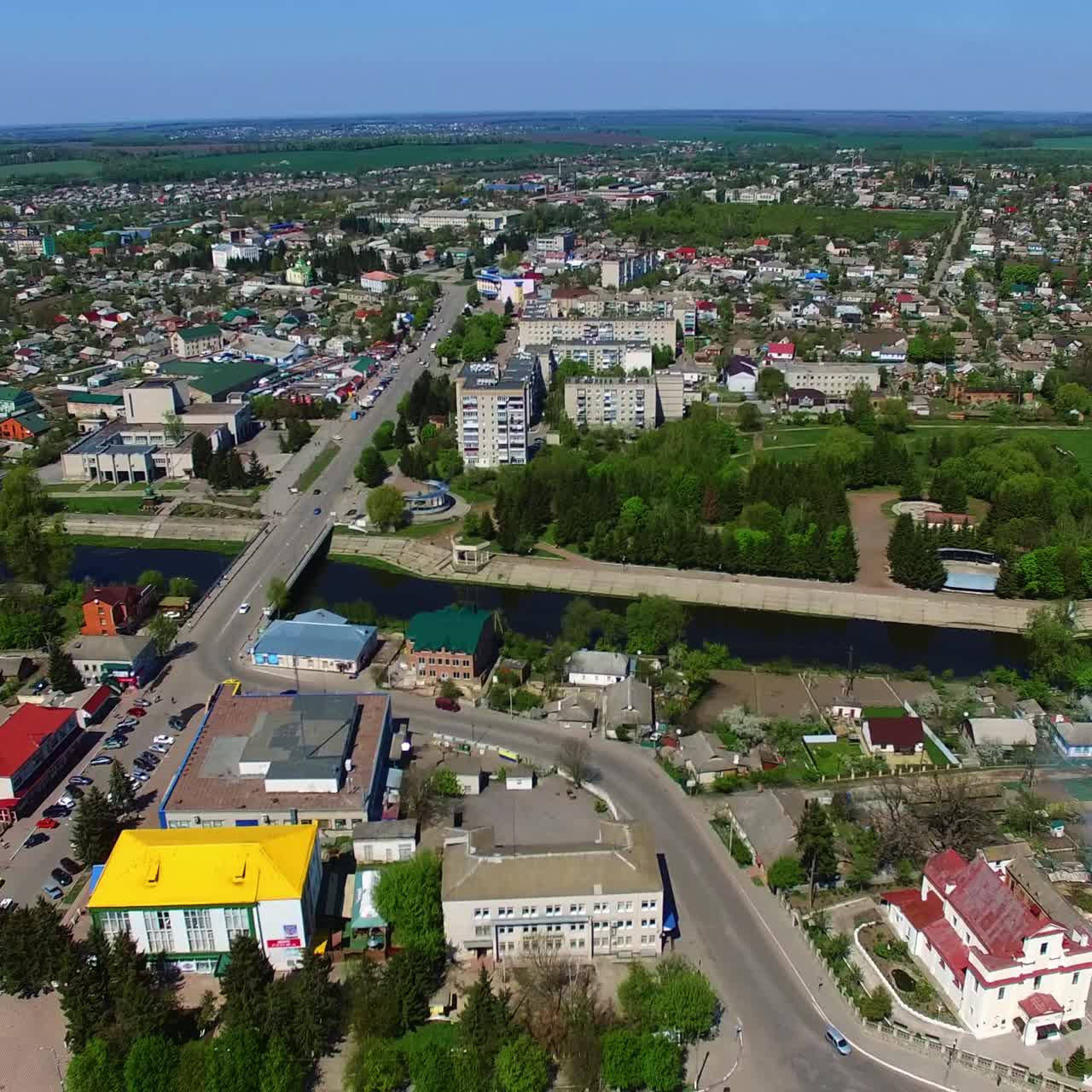 Cityscape of the urban city on sunny daytime. River floating through the landscape. City full of greenery. Top view