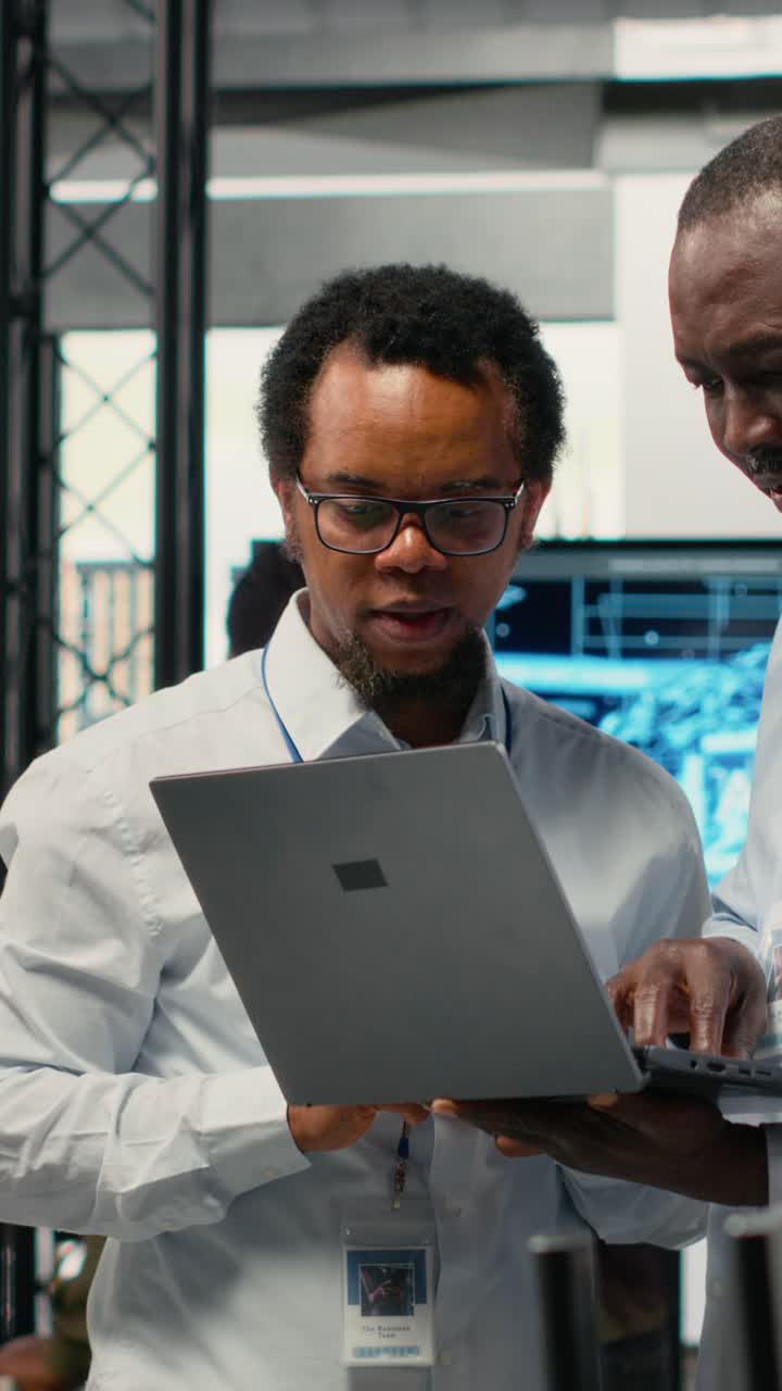 Vertical video Programmers in office doing software development, brainstorming