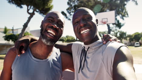 two african american men smiling on a basketball court
