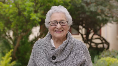 portrait-of-frail-elderly-woman-in-garden-laughing-cheerful-wearing-jumper