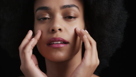 close-up-portrait-attractive-african-american-woman-touching-face-with-hands-caressing-smooth-healthy-skin-complexion-enjoying-perfect-natural-beauty-funky-afro-on-black-background