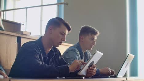 Large-Group-of-Multi-Ethnic-Students-Working-on-the-Laptops-while-Listening-to-a-Lecture-in-the-Modern-Classroom.-Bright-Young-People-Study-at-University.