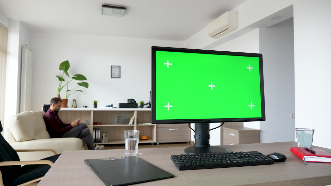 Office Setup with Green Screen Monitor