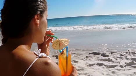 woman having mocktail on the beach