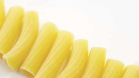 Close-up-of-tube-pasta-on-white-background