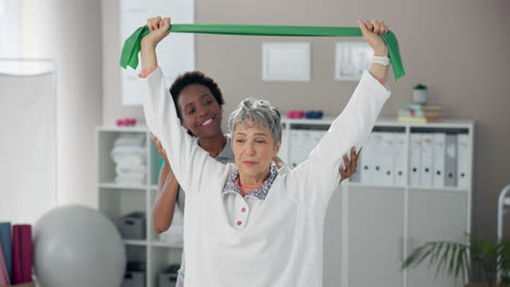 senior woman exercising with resistance band and therapist