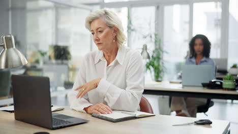 business woman writing in notebook at office