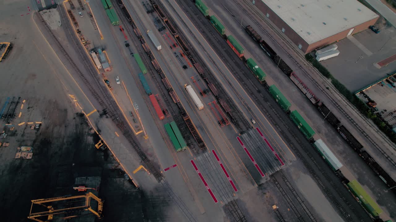 yard jockey trucks driving with trailers in a Intermodal Terminal Rail road with yard full of containers with Chicago in background