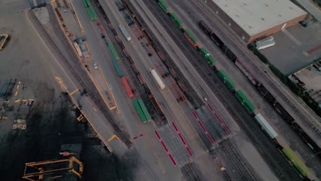 yard jockey trucks driving with trailers in a intermodal terminal rail road with yard full of containers with chicago in background