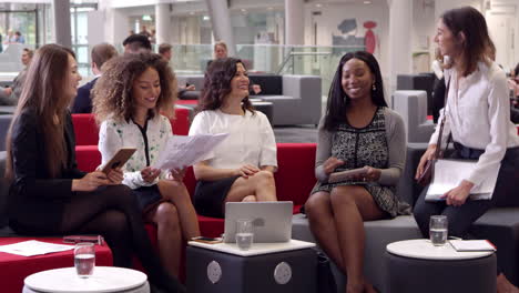 businesswomen meeting in lobby of modern office shot on r3d