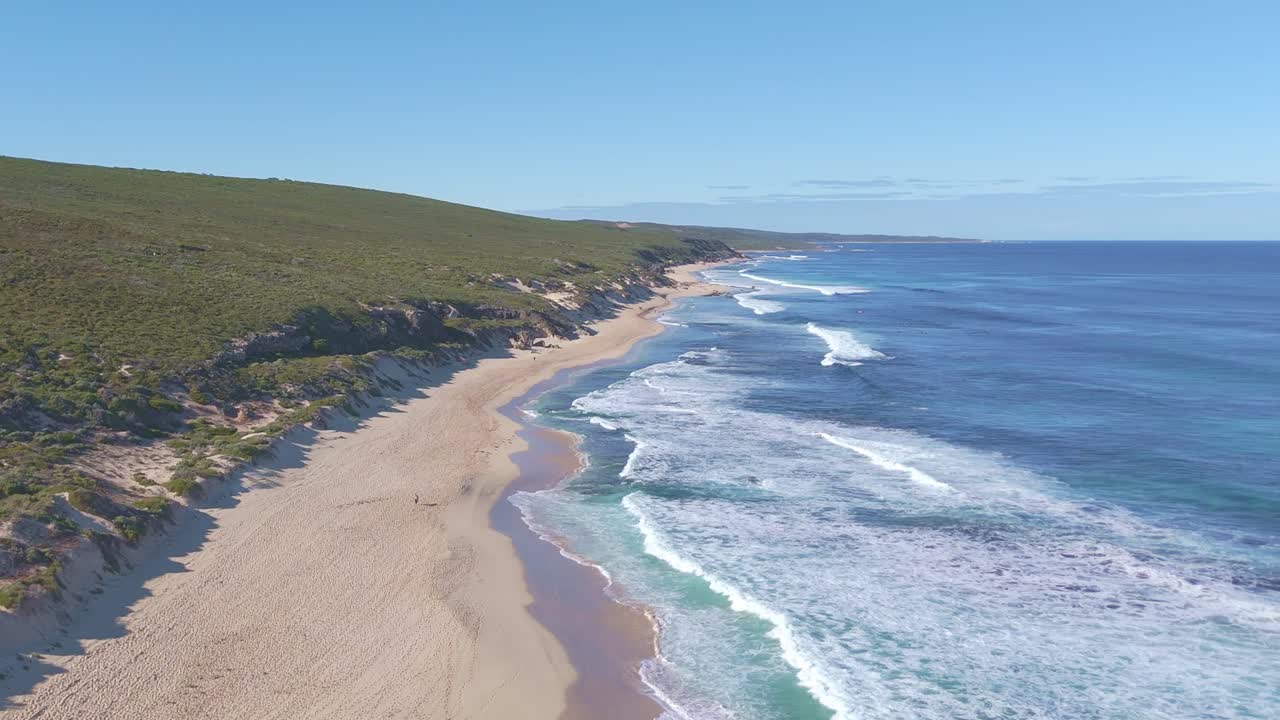 Aerial drone shot of Left Hander Bay, Margaret River, showing powerful ocean waves breaking over a shallow reef