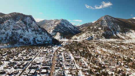 winter bluebird sky daytime noon snowy downtown frisco aerial drone high altitude main street colorado mountain ski town copper ikon pass breckenridge silverthorne dillon summit county left circle