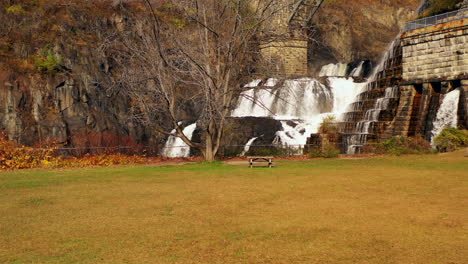 hovering-drone-shot-of-the-waterfalls-at-the-New-Croton-Dam-in-Westchester-County,-NY-on-a-cloudy-fall-morning,-while-the-park-was-empty