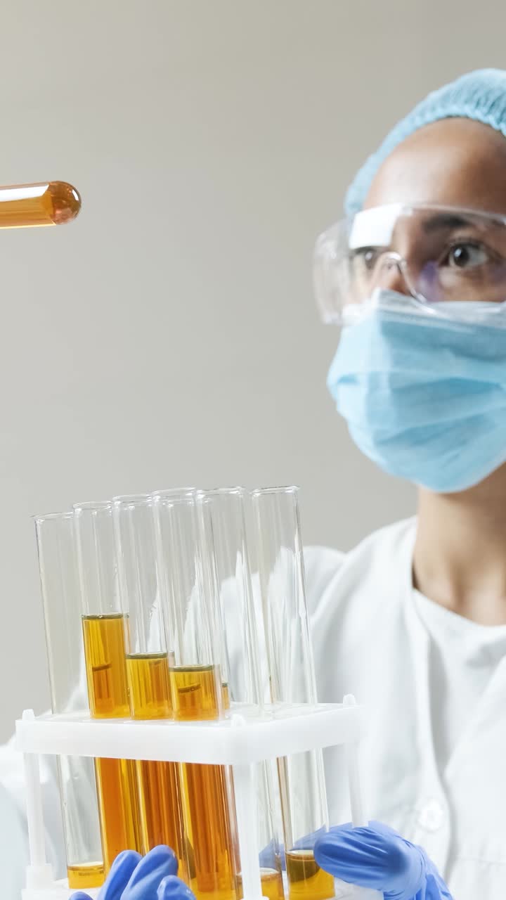 Scientist conducting experiments with test tubes in a lab