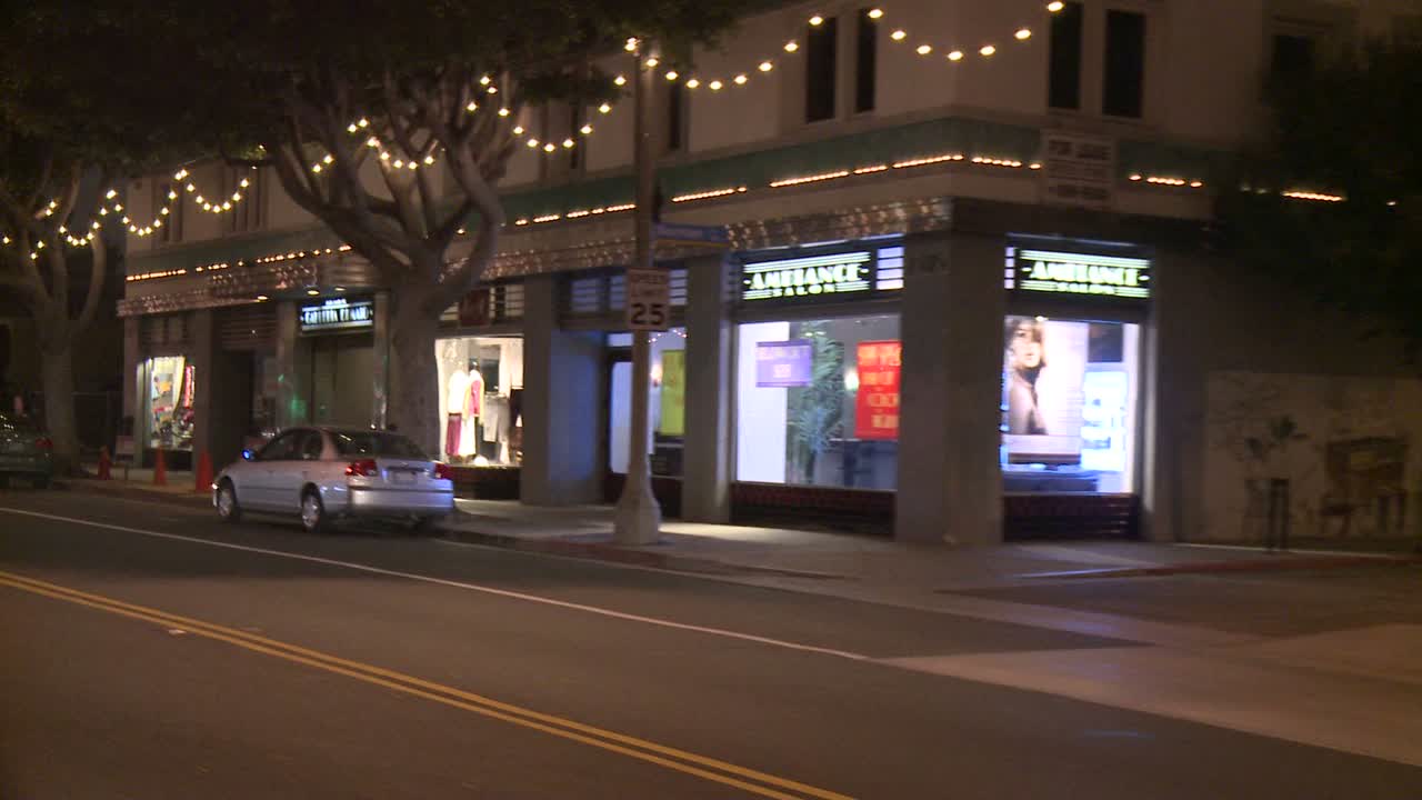 un auto viaja a lo largo de una calle en la noche en santa monica california como se ve a través de la ventana trasera en un ángulo 1