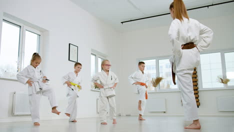 kids in white kimono in martial arts class