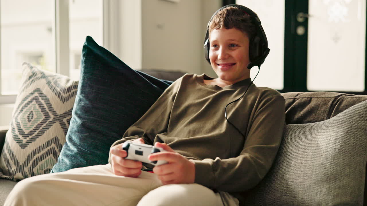 Boy playing video games on couch