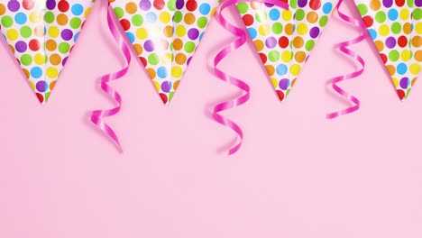 party flag banners with ribbons appear on pastel pink theme with happy birthday candles. stop motion