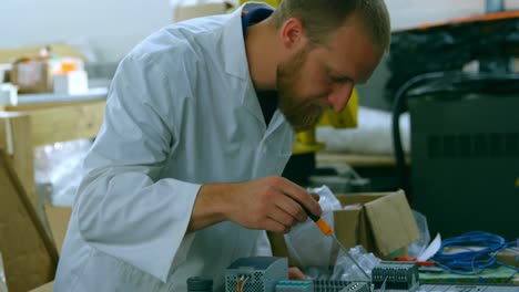 Robotic-engineer-examine-circuit-board-at-table-4k