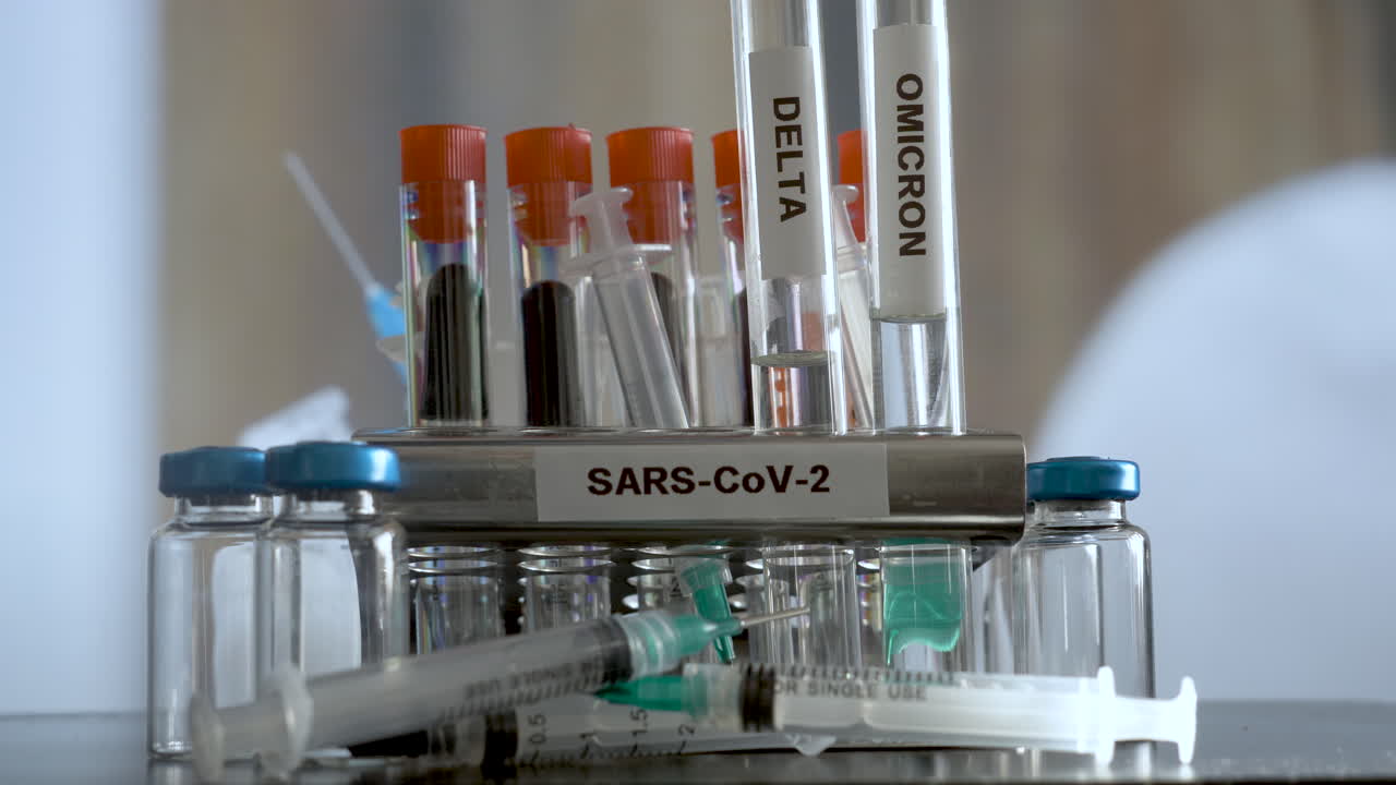 SARS COV 2 Test Tubes Labelled Alpha Gamma Delta Beta And Omicron Being Removed From Rack