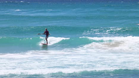 a surfer progressively riding and navigating a wave.