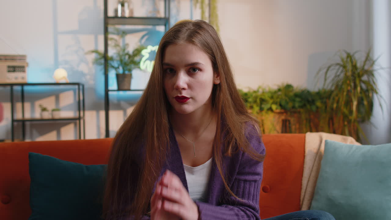 Woman presses finger to lips makes silence hush sign do not tells gossip secret quiet at home