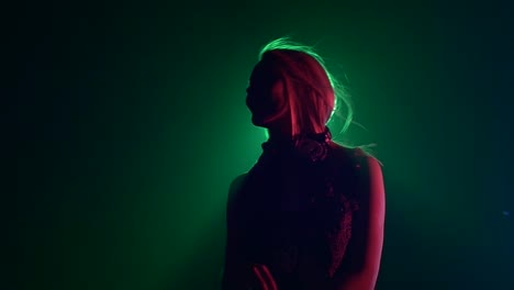 woman silhouetted in colorful stage lighting