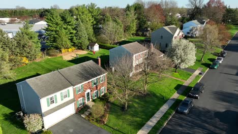 Aerial establishing shot of houses and homes in American neighborhood during spring