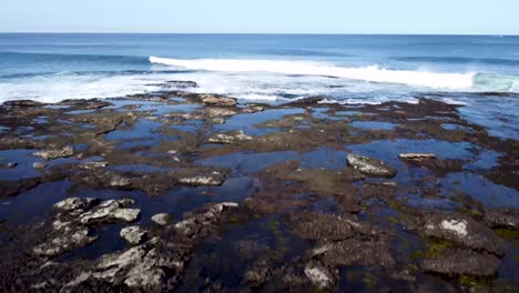 aerial shot of rock formation in the ocean.