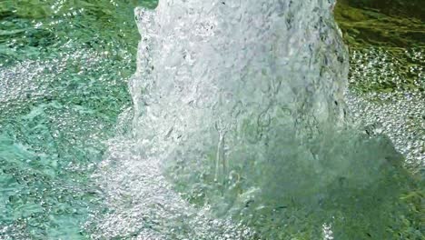 extreme close up of a water fountain sparkling and glistening and splashing