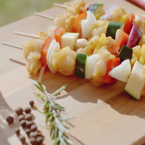 four chicken and vegetable kabobs on cutting board