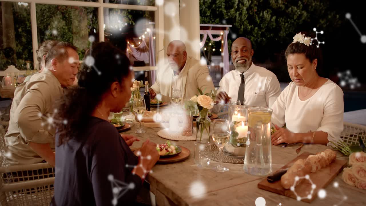 6 adults raising glasses after one proposing toast, celebrating dining; particles floating in front