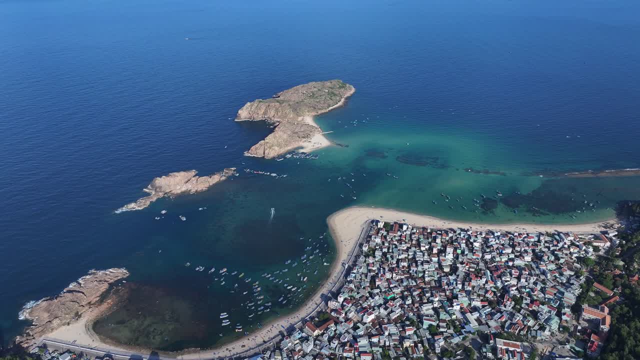 Aerial view of a coastal city with an island in the sea