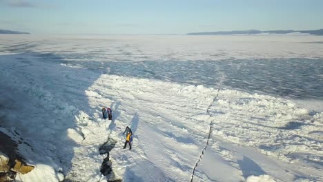 people exploring frozen lake