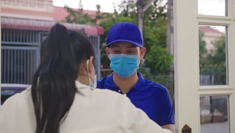 delivery person and customer at door
