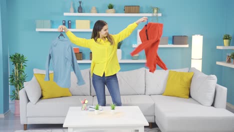 Young-girl-trying-to-choose-clothes-by-dancing.