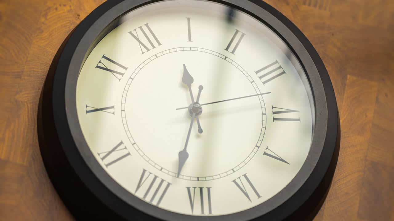 Close up timelapse a wall clock, with running time pointer.