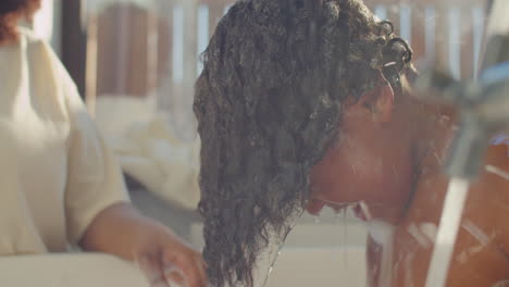 kid diving in water while bathing with mom