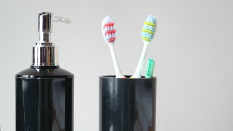 black bathroom accessories with toothbrushes