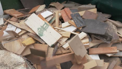 Throwing-scrap-wood-off-cuts-onto-pile-real-time-shot