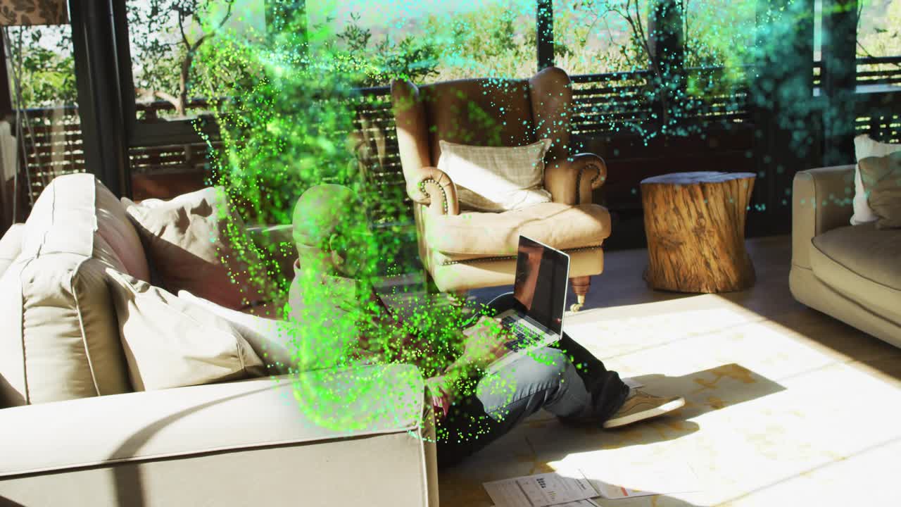 Senior remote worker typing laptop sparking green vfx wrapping laptop then fading for cloud tech